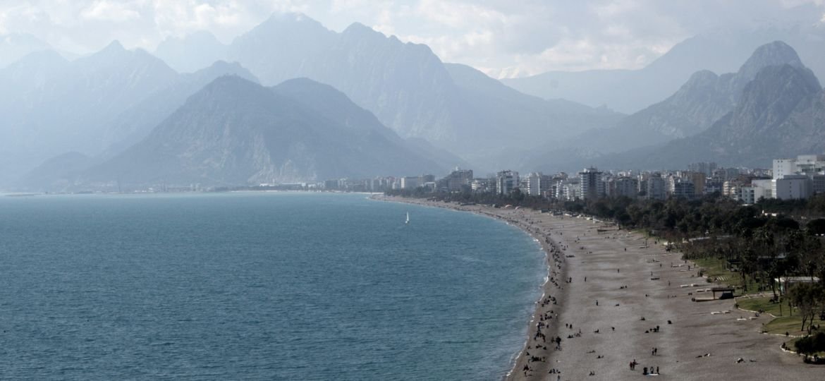 a view of a beach with mountains in the background