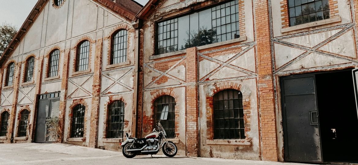 black motorcycle parked in front of brown concrete building