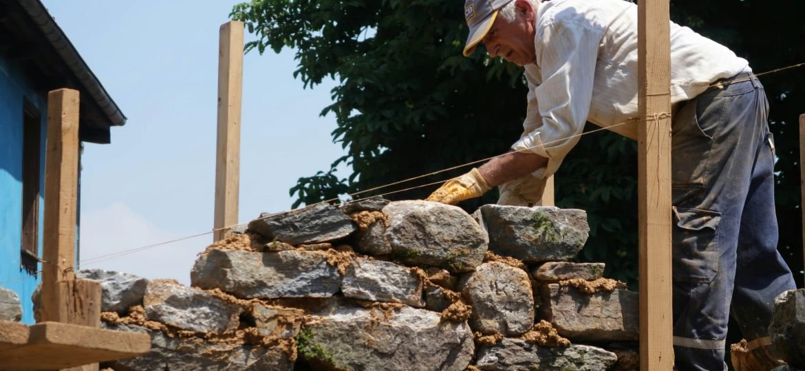 man piling bricks